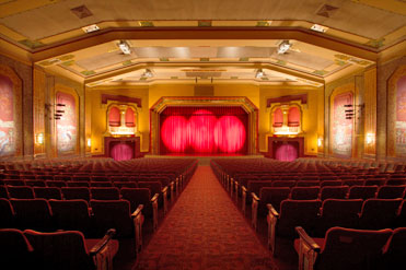 Stage curtains are lit by spotlights in the Paramount Bristol's art deco theater.